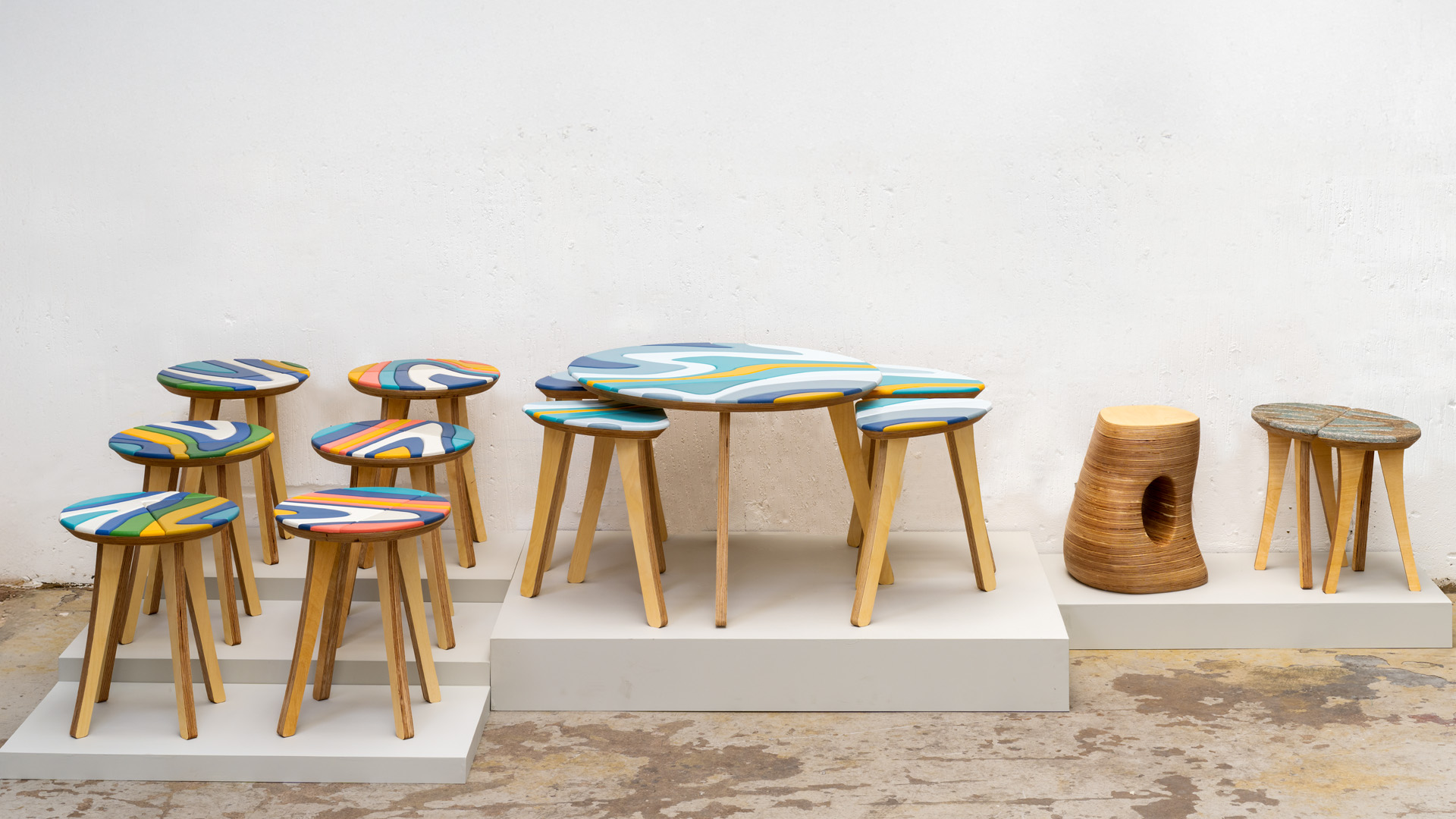 A family of stools and side tables, all made in small batches using a mix of birch ply and recycled materials. 