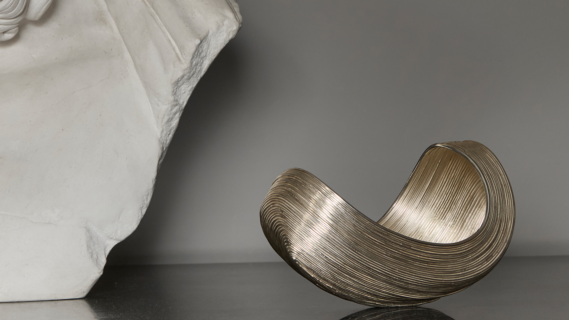 Nan Nan Liu maker silver bowl on table next to sculpture
