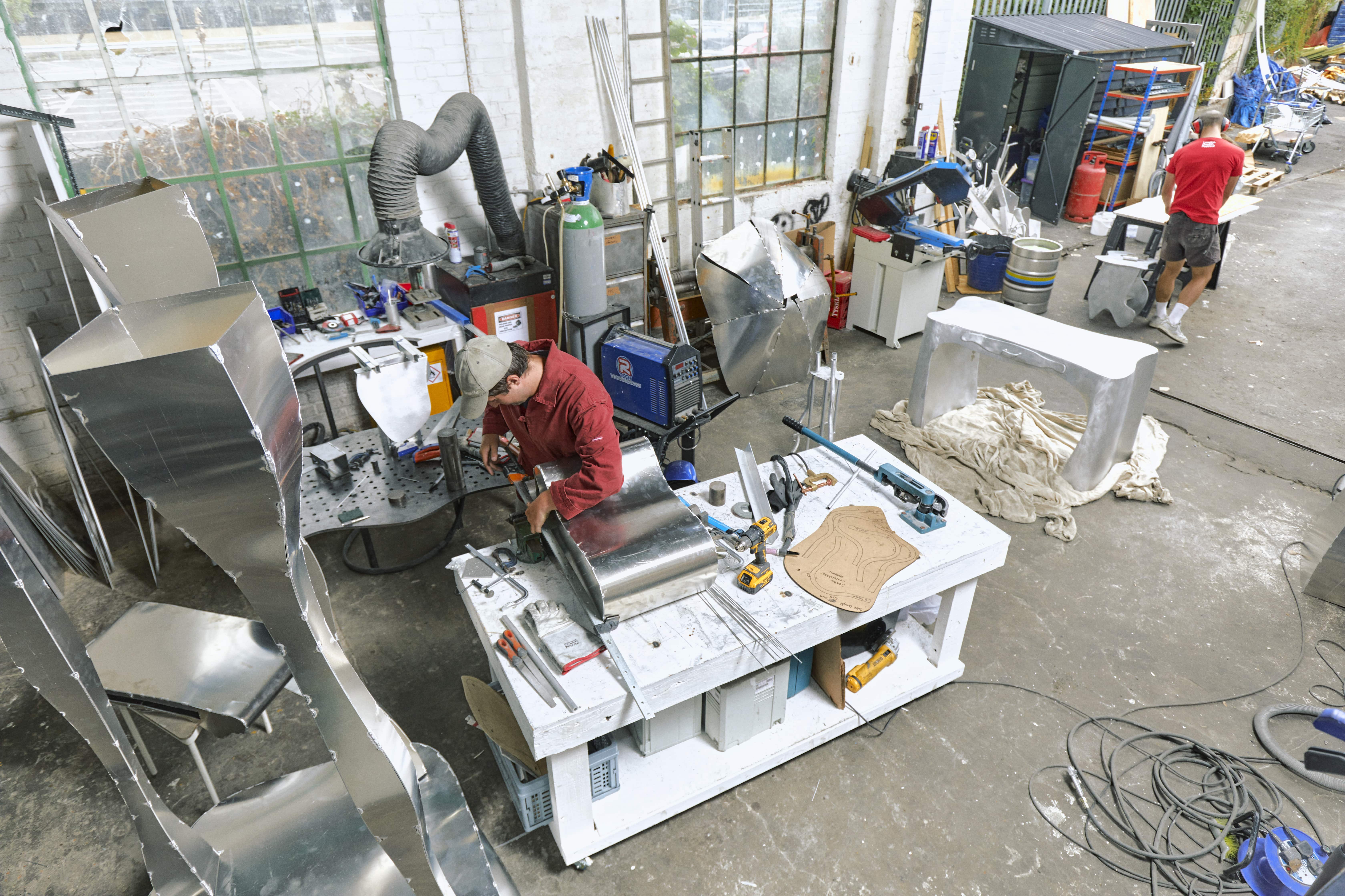 Two men in a metal workshop